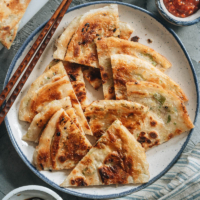 Super crispy and flaky on the outside and slightly chewy inside, my dim sum favorite, scallion pancakes, make a wonderful snack that you’ll love! {Vegan}