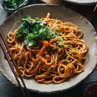 Try this savory hot dry noodle dish with a rich sauce and pickles on top for an authentic Chinese street food meal! {Vegan-Adaptable}