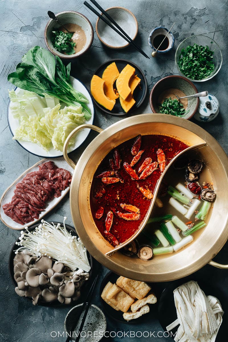 Hot pot with Sichuan spicy soup and non-spicy soup and spread of ingredients