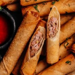 Close-up of Lumpia Shanghai cut open showing pork and vegetable filling.