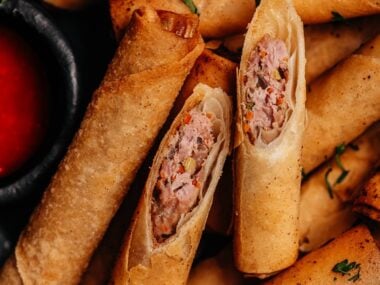 Close-up of Lumpia Shanghai cut open showing pork and vegetable filling.