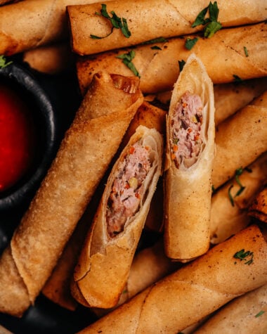 Close-up of Lumpia Shanghai cut open showing pork and vegetable filling.