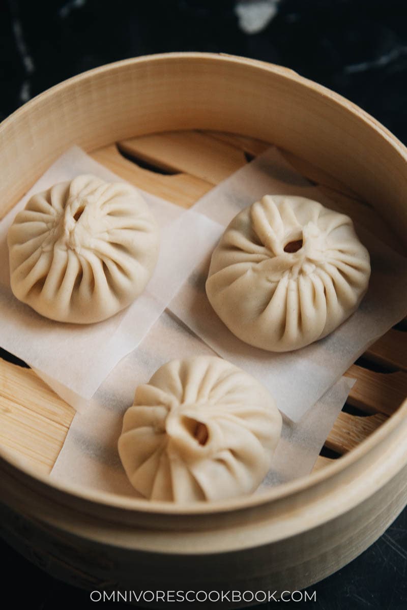 Uncooked Xiao Long Bao in a bamboo steamer