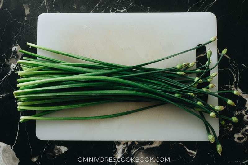 Fresh garlic chives on a cutting board