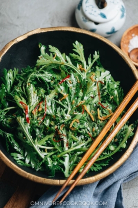 Chrysanthemum greens in a bowl with Asian dressing