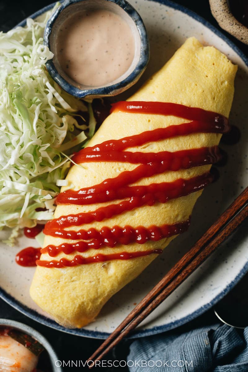 Kimchi fried rice omelet with tomato ketchup and cabbage salad