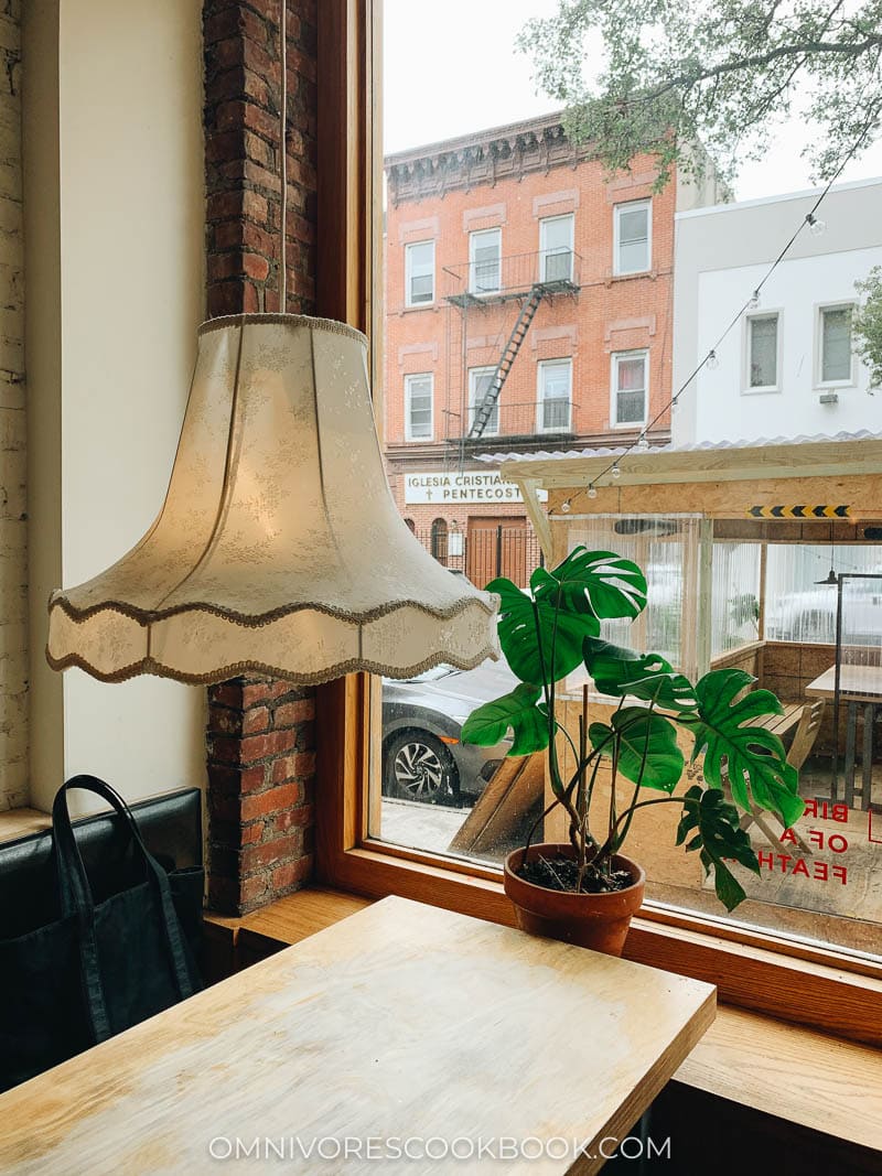 An old-fashioned lamp hanging over a restaurant table