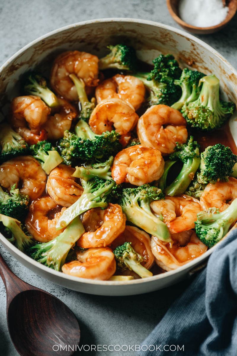 Chinese style shrimp in a skillet with green vegetables