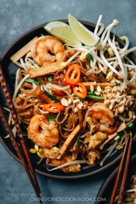 Easy shrimp fried noodles with egg and tofu, peanuts, chili pepper, and lime