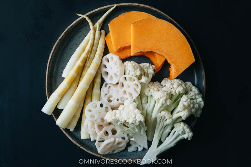 Bamboo shoot, lotus root, cauliflower and squash on a plate