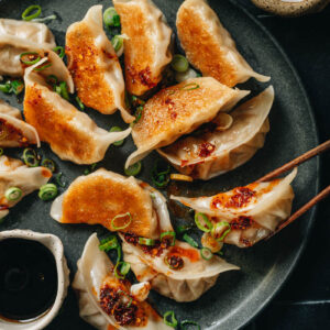 Pan fried dumplings with chili oil and scallion
