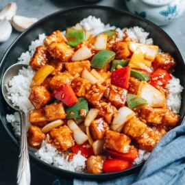 Sweet and sour tofu with pepper and onion over steamed rice