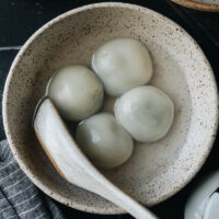 Gooey sweet rice balls (Tang Yuan) with a buttery runny sweet black sesame filling, they have a delightful texture and a delicate taste. It is a perfect healthy dessert for your Chinese meals or celebrating the Lantern Festival. {Vegetarian, Gluten-Free}