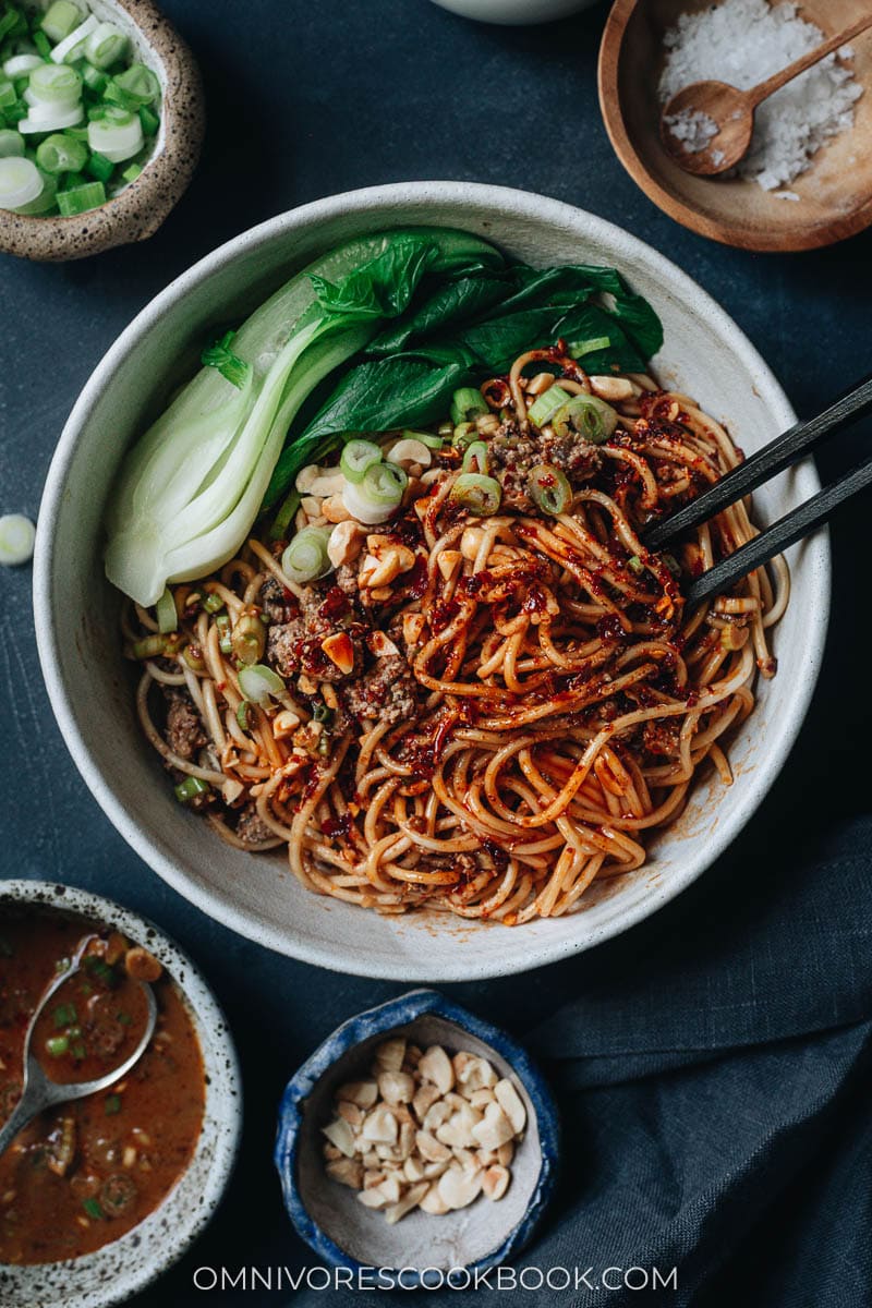 Mixing vegan dan dan noodles with chopsticks