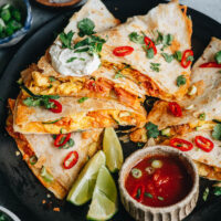 Quick and easy breakfast quesadilla made with scrambled eggs, sauteed kimchi, zucchini, and melty cheese. It takes no time to put together and is colorful and super hearty. Making a fun, balanced, and nutritious breakfast couldn’t be easier! {Vegetarian Adaptable}