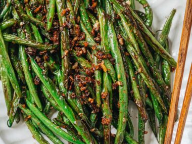 Charred and blistered green beans cooked with minced garlic