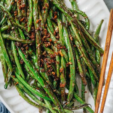 Charred and blistered green beans cooked with minced garlic