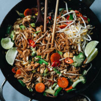 This homemade chicken pad thai is bursting with fresh, bright flavors and handily beats takeout. It’s quick and easy and is all about helping each ingredient shine and without any fish sauce! The toothy rice noodles combine with a sweet-sour-spicy sauce that is just irresistible. {Gluten-Free}