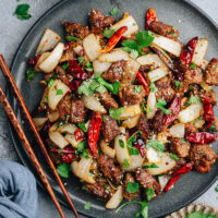 Real-deal Xinjiang cumin lamb recipe that yields crispy juicy lamb pieces coated with a bold cumin chili spice mix, stir fried with onion, garlic and cilantro. It’s a dish you can easily make at home, and it tastes just like what you’d get in China. {Gluten free adaptable}