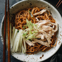 Chinese chicken noodle salad is a perfect summer dish. Thin noodles are tossed in a nutty, aromatic and savory sesame sauce and topped with tender shredded chicken and crunchy cucumber. It’s super easy to prepare, can be cooked ahead for meal prep, and is addictively tasty! {Gluten-Free Adaptable}