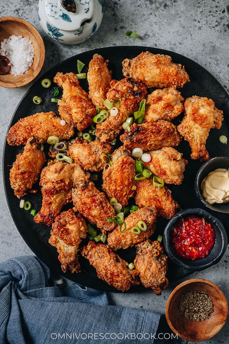 Air fryer chicken wings served on a platter with sauce