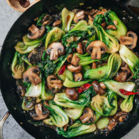 An easy bok choy mushroom stir fry that can be whipped together quickly for a speedy weekday dinner. The tender mushrooms and crisp bok choy are brought together with a gingery garlicky brown sauce, which tastes comforting and satisfying. Serve it as a side or a main course over steamed rice. {Vegan, Gluten-Free Adaptable}