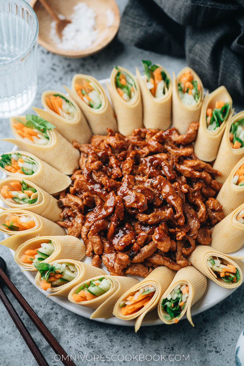 Serving Peking shredded pork with sweet bean sauce with tofu veggie rolls