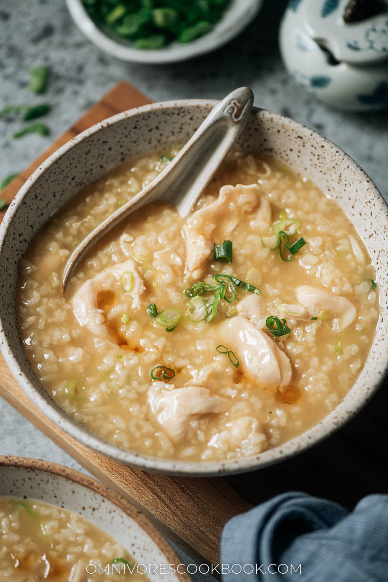 Chicken congee served with green onion and sesame oil