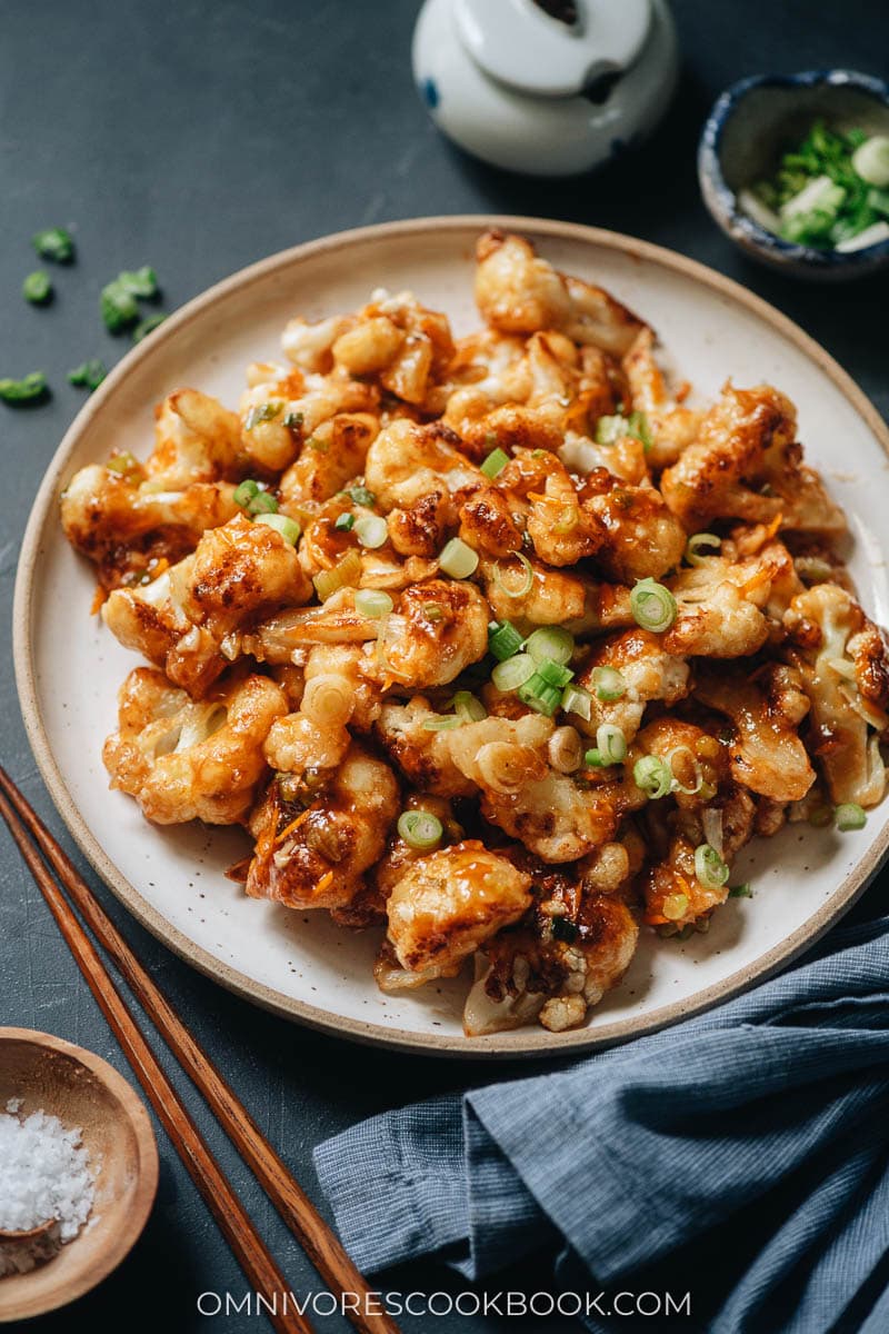 Pan fried cauliflower with orange sauce topped with green onions