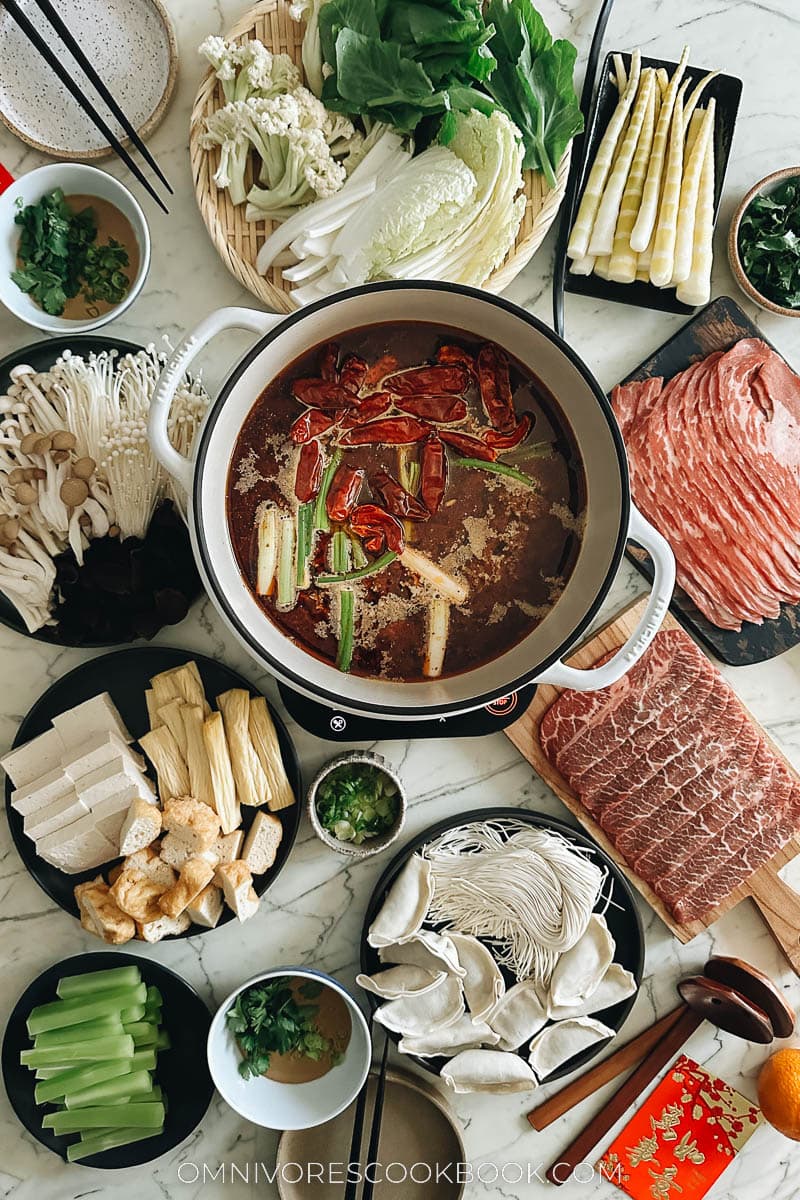 Chinese hot pot spread with meat, vegetables, dumplings and noodles