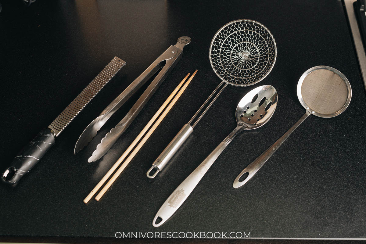 Tongs, cooking chopsticks, slotted spoons, spider, zester, and fine mesh strainer