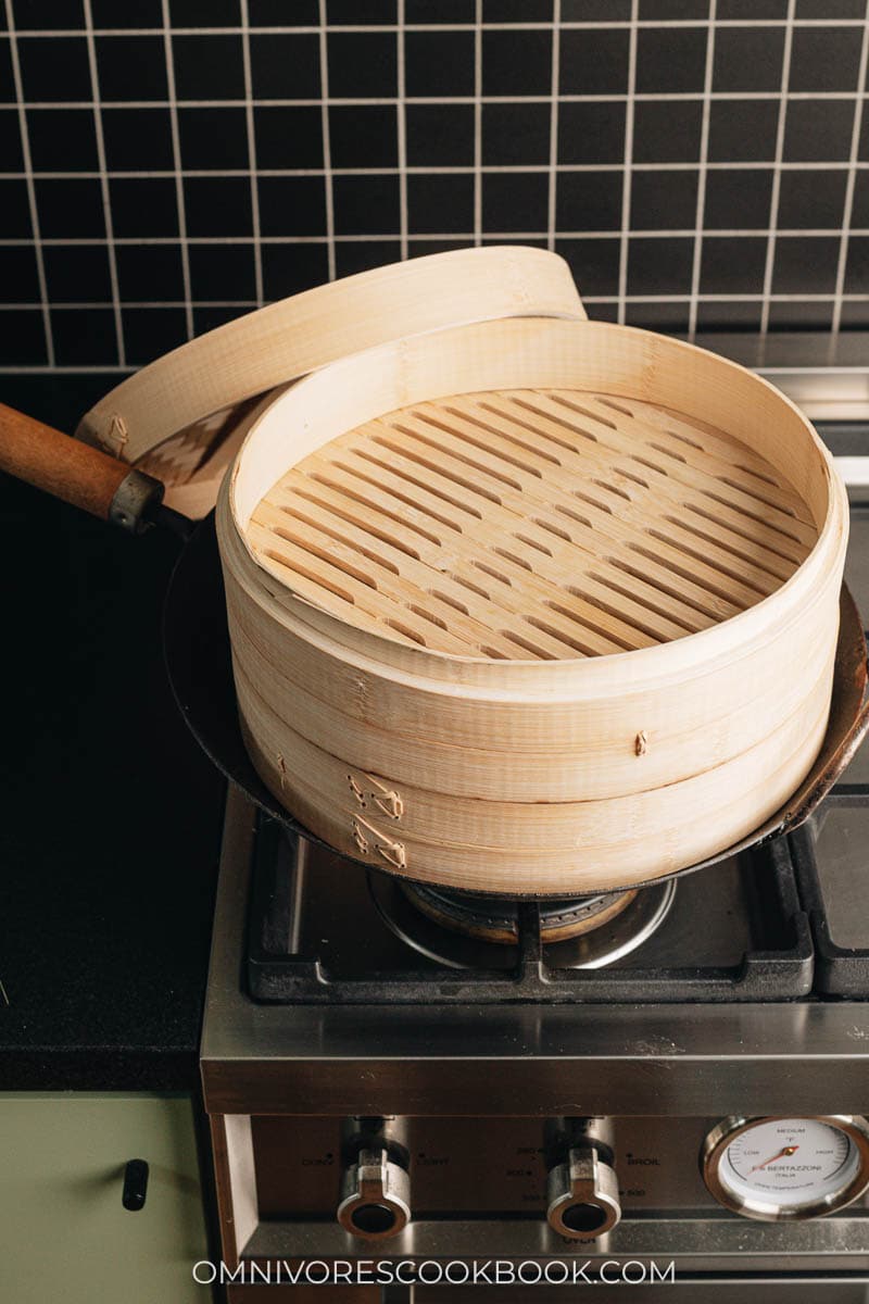 Bamboo steamer set up on a wok