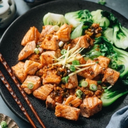 These pan fried salmon bites are crispy on the outside and soft and moist on the inside. They are served with a gingery, garlicky savory sauce and steamed bok choy. {Gluten-Free Adaptable}