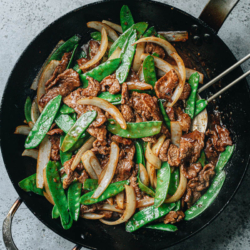 Beef with snow peas features tender juicy steak stir fried with crisp snow peas in a gingery, garlicky brown sauce. It is a satisfying and nutritious dish that takes less than 30 minutes to make - perfect for a weekday dinner. {Gluten-Free Adaptable}
