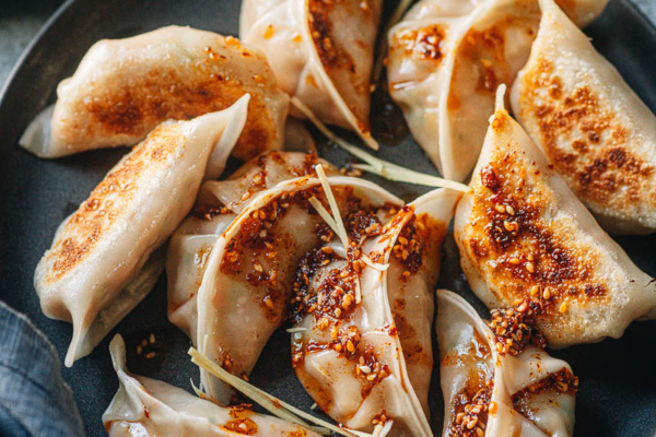 Chinese chicken dumplings served with dipping sauce and chili oil
