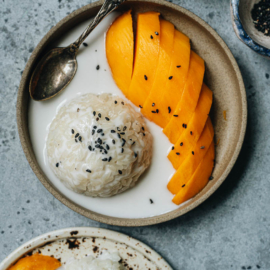 Traditional Thai mango sticky rice with black sesame seeds topping