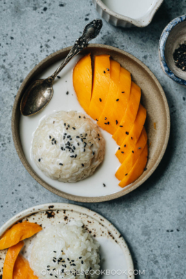 Traditional Thai mango sticky rice with black sesame seeds topping