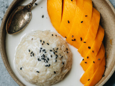 Traditional Thai mango sticky rice with black sesame seeds topping