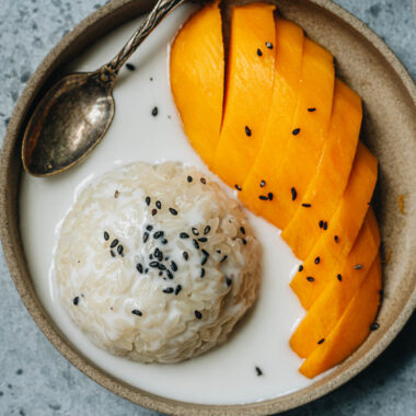 Traditional Thai mango sticky rice with black sesame seeds topping