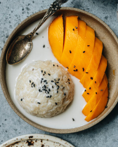 Traditional Thai mango sticky rice with black sesame seeds topping