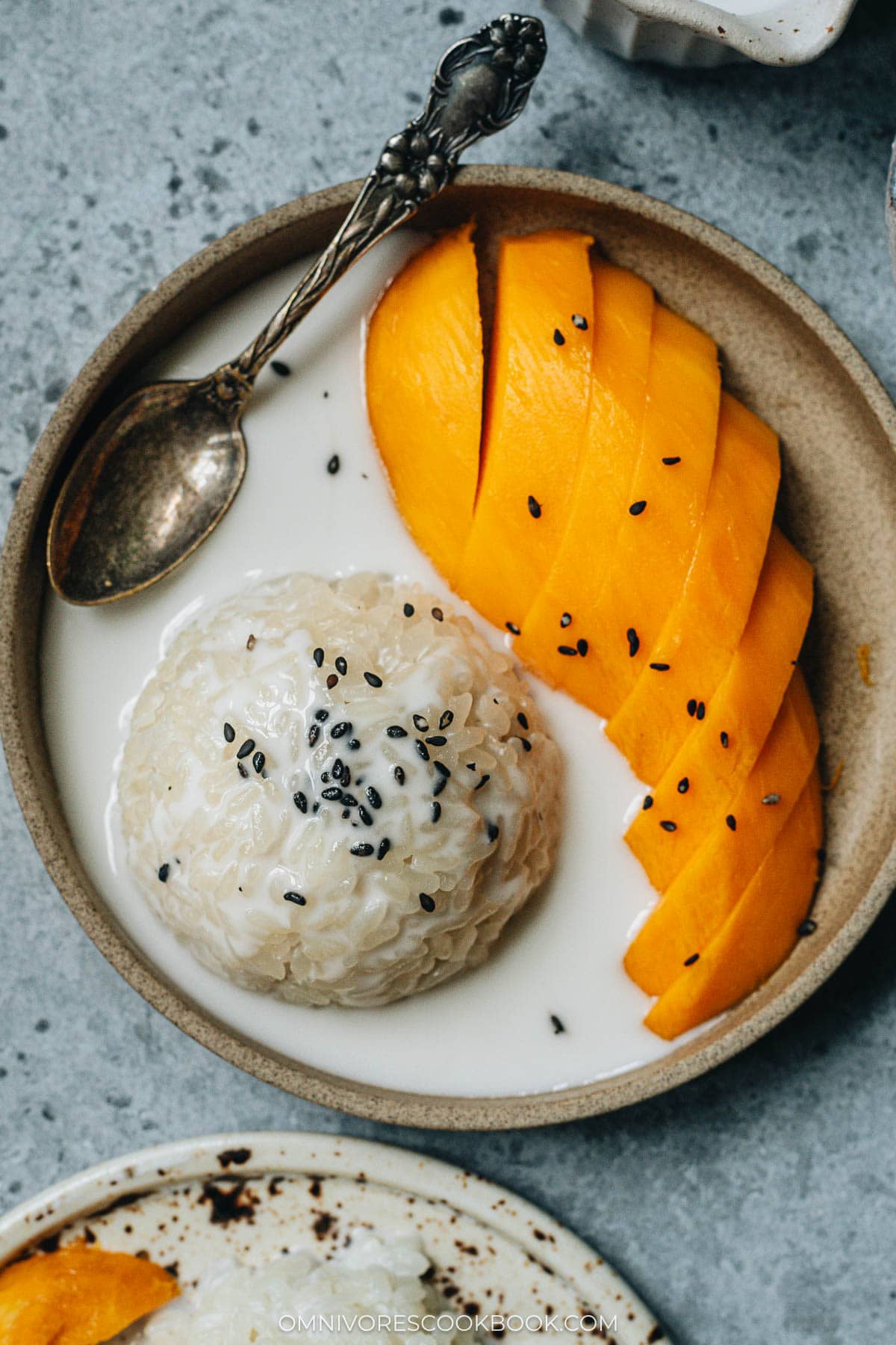 Traditional Thai mango sticky rice with black sesame seeds topping
