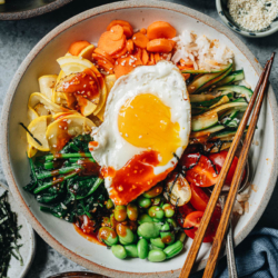 Summer vegetable bibimbap is loaded with colorful and bright seasonal vegetables and sunnyside egg, and brought together with a spicy sweet chili sauce. {Vegetarian, Gluten-Free Adaptable}