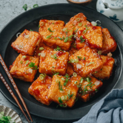 Pan fried tofu is a fun homestyle dish that features meaty tofu bites with a crispy coating and a sweet and sour sauce. Topped on the rice, it is an easy and flavorful way to whip up a vegetarian one-bowl meal that everyone will love! {Vegetarian, Gluten-Free Adaptable}