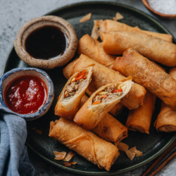 These chicken egg rolls are crispy on the outside and filled with a tasty, textured filling of chicken, bamboo shoots, mushrooms, and carrots. Learn how to make chicken egg rolls from scratch in no time at all!