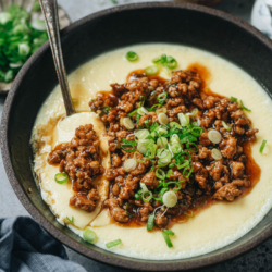Steamed egg with minced pork is a comforting dish that you can enjoy at any time of day. The silky and tender egg curd is topped with crispy minced pork in a savory gravy. It takes less than 30 minutes to put together this delicious one-bowl meal. {Gluten-Free Adaptable}