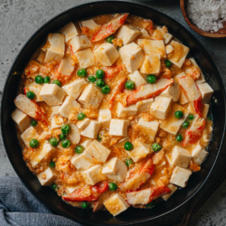 Crab roe tofu made with salted duck egg yolks is a simple and decadent main dish that you can put together in no time. The silky and soft tofu is braised in a savory broth that is bursting with umami. Served it over steamed rice for a satisfying meal in under 30 minutes. {Gluten-Free}