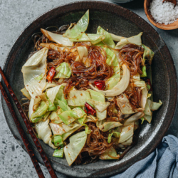 Cabbage glass noodle stir fry is a quick homestyle side dish that takes 10 minutes to put together. The crisp cabbage and tender mung bean noodles are brought together with a savory sauce, making it satisfying and comforting to eat. {Vegan, Gluten-free adaptable}