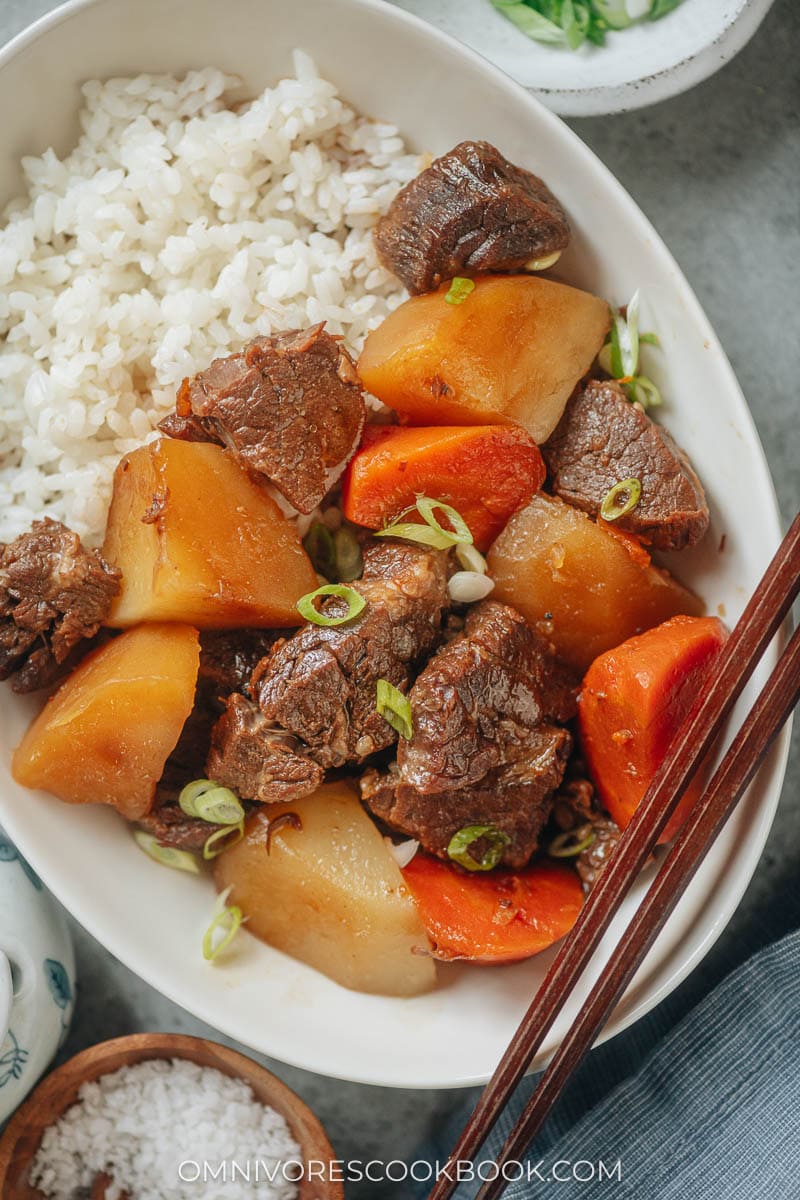Chinese beef stew served with rice close up