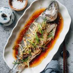 Chinese steamed fish is always a centerpiece on the dinner table at Chinese New Year and other celebratory occasions. Not only is the fish juicy and extra fragrant, it has a stunning appearance and symbolizes good luck. Learn how to make this easy dish in your own kitchen. The method for cooking a fish filet is also included. {Gluten-Free Adaptable}
