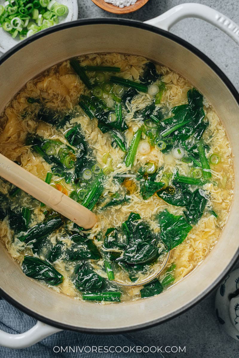 Spinach egg drop soup in a pot close up